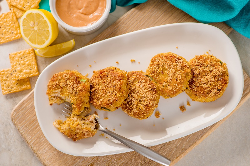 Crunchmaster-cracker-coated crab cakes with creamy cocktail sauce.