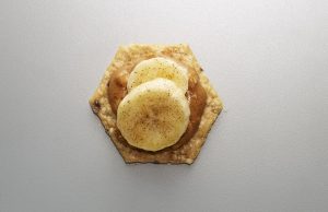 Crunchmaster Multi-Seed cracker with bananas and peanut butter on top.