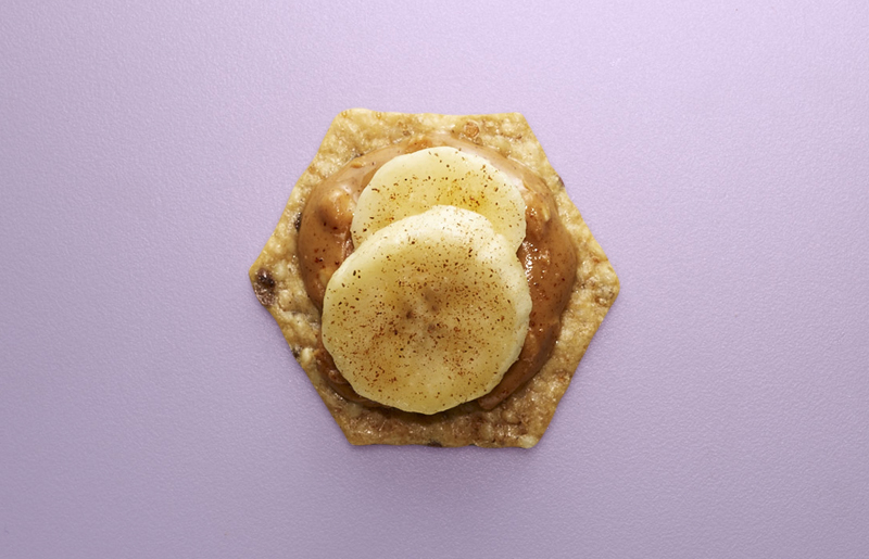Crunchmaster cracker with peanut butter and bananas on top.