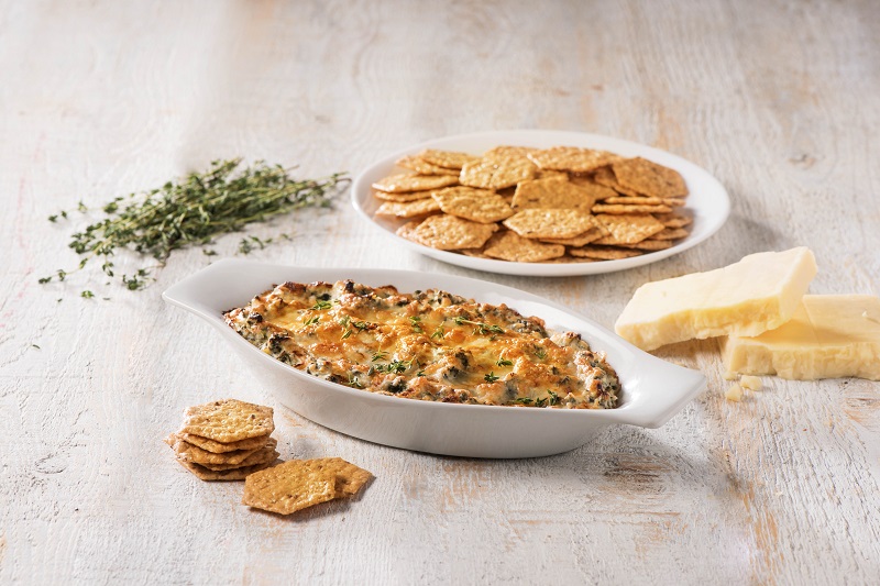 Warm spinach and artichoke dip with Cruncmaster crackers.
