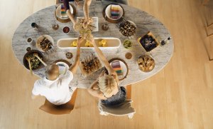 Overhead view of a dinner party including Crunchmaster crackers.