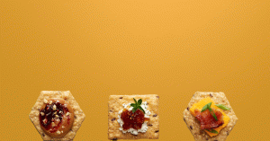 Three different Crunchmaster crackers with assorted toppings.