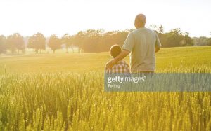 Father and son in a grain field.